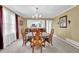 Bright dining room with large windows, offering ample natural light and cozy charm at 6690 Pine Ridge Cir, Cumming, GA 30041