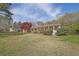 Ranch-style house featuring a red metal roof, a covered porch, and a well-maintained lawn at 6690 Pine Ridge Cir, Cumming, GA 30041
