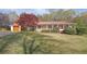 Charming home with a red metal roof, a covered front porch, and a well-manicured lawn at 6690 Pine Ridge Cir, Cumming, GA 30041