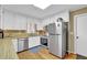 Bright kitchen features stainless steel appliances and ample counter space for food preparation at 6690 Pine Ridge Cir, Cumming, GA 30041