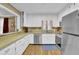 Bright kitchen featuring wood floors, stainless steel appliances, and generous countertop space at 6690 Pine Ridge Cir, Cumming, GA 30041