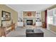 Comfortable living room with a stone fireplace, built-in shelves, carpet, and neutral-colored walls at 6690 Pine Ridge Cir, Cumming, GA 30041