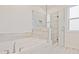 An inviting bathtub next to a frameless glass shower that is well-lit by natural light, creating a refreshing space at 4212 Adler Cir, Buford, GA 30519