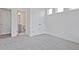 Bedroom with plush carpeting and double-door closet adjacent to an ensuite bathroom with modern features at 4212 Adler Cir, Buford, GA 30519