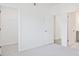 Spacious bedroom boasts walk-in closet and ensuite bath, neutral walls and carpet at 4212 Adler Cir, Buford, GA 30519