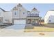 Two-story home featuring a brick and siding facade, a spacious driveway, and well-maintained landscaping at 4212 Adler Cir, Buford, GA 30519