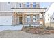 Inviting front porch with brick and wood columns, creating a warm entry to the home at 4212 Adler Cir, Buford, GA 30519