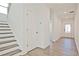 Hallway featuring hardwood floors and staircase with natural light, leading into the home at 4212 Adler Cir, Buford, GA 30519