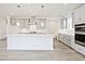 Well-lit kitchen featuring a large island, stainless steel appliances, and plenty of cabinet space at 4212 Adler Cir, Buford, GA 30519