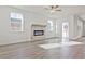 Bright living room featuring a modern fireplace, hardwood floors and ample sunlight at 4212 Adler Cir, Buford, GA 30519