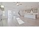 Bright open-concept space featuring hardwood floors, seamlessly connecting living, dining, and kitchen areas at 4212 Adler Cir, Buford, GA 30519