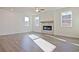 Inviting living room features a modern fireplace, light hardwood floors and ample sunlight at 4212 Adler Cir, Buford, GA 30519
