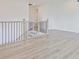Loft area featuring modern flooring, iron railings, and an open layout, creating an inviting atmosphere at 4212 Adler Cir, Buford, GA 30519