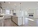 Bright, open-concept layout featuring a modern kitchen with stainless steel appliances and a cozy fireplace at 4212 Adler Cir, Buford, GA 30519