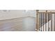 Staircase with wooden handrail and black iron spindles, complemented by modern floors and natural light at 4212 Adler Cir, Buford, GA 30519