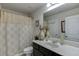 Bathroom featuring a vanity with a sink, a large mirror, and a shower with a floral curtain providing both functionality and comfort at 4685 Orchard View Way, Cumming, GA 30028