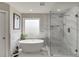 Modern bathroom featuring a soaking tub, glass enclosed shower, and marble accent wall for a luxurious and stylish design at 4685 Orchard View Way, Cumming, GA 30028