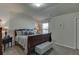 Bedroom featuring a cozy bed, bedside lamps, and a window for a comfortable and relaxing space at 4685 Orchard View Way, Cumming, GA 30028
