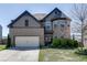 Charming two-story home with a well-manicured lawn, brick facade, and inviting double-door entryway at 4685 Orchard View Way, Cumming, GA 30028