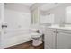 Bright full bathroom with tub, shower, white tile, and vanity with storage space at 1577 Linksview Close, Stone Mountain, GA 30088