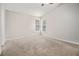 Neutral bedroom with plush carpeting, two corner windows, and a ceiling fan at 1577 Linksview Close, Stone Mountain, GA 30088