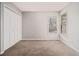 Comfortable bedroom featuring neutral walls, carpeted floors, a double window and closet at 1577 Linksview Close, Stone Mountain, GA 30088