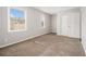 Bright bedroom featuring neutral walls, carpeted floors, a double window and closet at 1577 Linksview Close, Stone Mountain, GA 30088