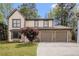 Charming home with a two-car garage and stone accents, complemented by a well-manicured lawn at 1577 Linksview Close, Stone Mountain, GA 30088