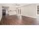 Open-concept living room with wood floors, a ceiling fan, and access to kitchen and backyard at 1577 Linksview Close, Stone Mountain, GA 30088