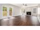 Spacious living room featuring wood floors, fireplace, and French doors leading to the backyard at 1577 Linksview Close, Stone Mountain, GA 30088