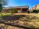 Backyard with overgrown lawn, trees and the back of a red brick house with a small porch at 3301 Henderson Mill Rd # 1, Atlanta, GA 30341