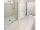 Modern bathroom with a glass-enclosed shower and white tile; open to a bedroom and closet space at 3301 Henderson Mill Rd # 1, Atlanta, GA 30341