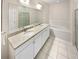 Elegant bathroom with double sink vanity, granite counters, white cabinets, soaking tub and glass shower at 3301 Henderson Mill Rd # 1, Atlanta, GA 30341