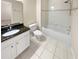 Bright bathroom features granite countertop, a commode, and a soaking tub with updated tile work at 3301 Henderson Mill Rd # 1, Atlanta, GA 30341