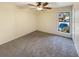 Carpeted bedroom with ceiling fan and a large window at 3301 Henderson Mill Rd # 1, Atlanta, GA 30341