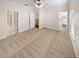 Spacious bedroom with neutral carpet, ceiling fan, and multiple doorways for easy access to other areas at 3301 Henderson Mill Rd # 1, Atlanta, GA 30341