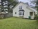 Backyard featuring vinyl siding, a fenced yard, a porch, and mature trees at 5980 Sherwood Trce, Lithonia, GA 30038