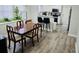 Dining area with a kitchen view, featuring a lovely table and chairs, and a bright, plant-filled window at 5980 Sherwood Trce, Lithonia, GA 30038