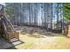 Grassy backyard bordered by mature trees and a privacy fence at 6463 Century Park Se Pl, Mableton, GA 30126