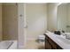 Neutral bathroom with a dark wood vanity, tile flooring, and a tub-shower combo with tan tiling at 6463 Century Park Se Pl, Mableton, GA 30126