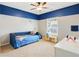 bedroom with two-tone blue and neutral walls, carpet, and a ceiling fan at 6463 Century Park Se Pl, Mableton, GA 30126