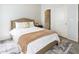 Cozy bedroom featuring a neutral color palette, plush bedding, and a doorway leading to an en-suite bathroom at 6463 Century Park Se Pl, Mableton, GA 30126