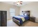 Bedroom featuring a rustic wooden bed frame, neutral walls, carpet, and a ceiling fan at 6463 Century Park Se Pl, Mableton, GA 30126