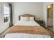 Comfortable bedroom with natural light, neutral colors, plush bedding, and a doorway leading to an en-suite bathroom at 6463 Century Park Se Pl, Mableton, GA 30126