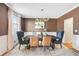 Elegant dining room featuring modern chandelier, stylish seating, and a large window for natural light at 6463 Century Park Se Pl, Mableton, GA 30126
