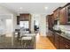 The kitchen has stainless appliances, dark cabinets, granite countertops, and wood floors at 6463 Century Park Se Pl, Mableton, GA 30126