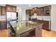 Spacious kitchen features dark wood cabinets, stainless steel appliances, granite countertops, and a large kitchen island at 6463 Century Park Se Pl, Mableton, GA 30126