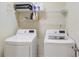 Bright laundry room featuring a modern washer and dryer set and wire shelving at 6463 Century Park Se Pl, Mableton, GA 30126