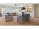Bright living room with built-in shelves, fireplace, and large windows offering serene outdoor views at 6463 Century Park Se Pl, Mableton, GA 30126