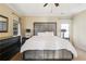 Main bedroom featuring a tray ceiling, carpeting, and a large upholstered headboard at 6463 Century Park Se Pl, Mableton, GA 30126